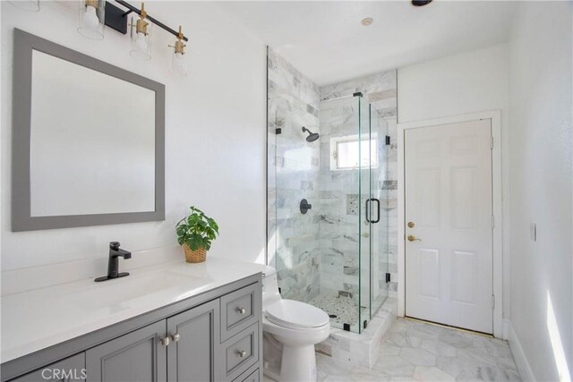 bathroom with toilet, a shower with shower door, and vanity