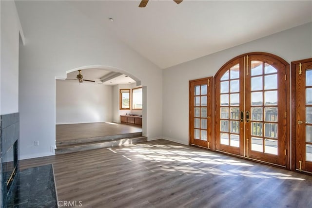 interior space with dark wood-type flooring, ceiling fan, lofted ceiling, and french doors