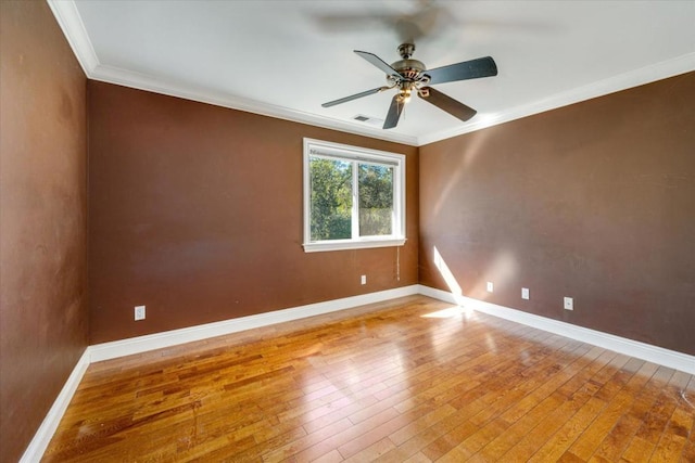 empty room with hardwood / wood-style flooring, ornamental molding, and ceiling fan