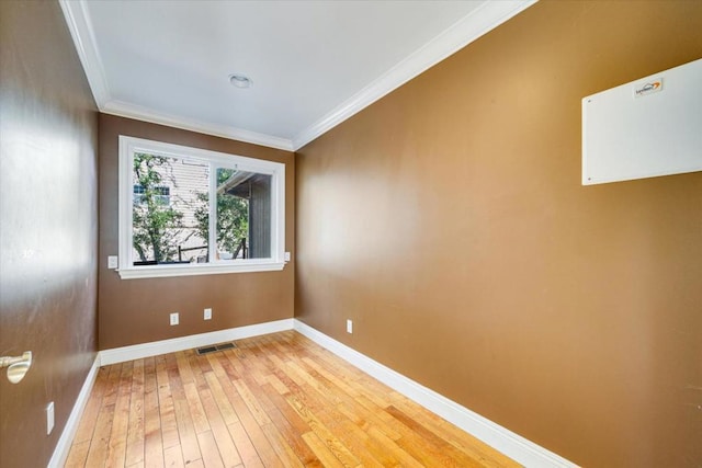 unfurnished room with crown molding and light hardwood / wood-style flooring