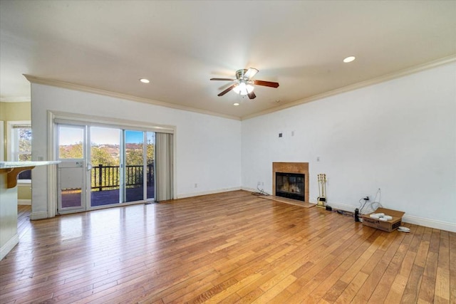 unfurnished living room featuring ceiling fan, ornamental molding, and light hardwood / wood-style floors