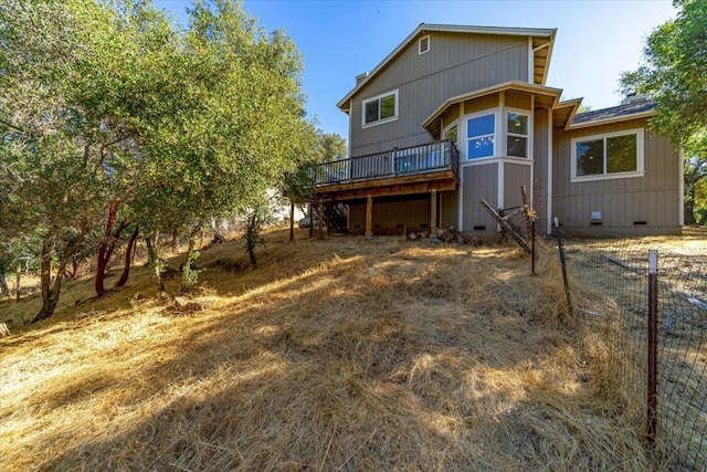 back of house with a wooden deck