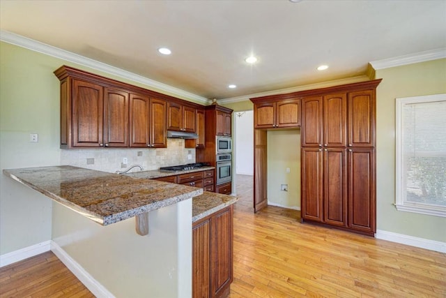 kitchen with stone counters, stainless steel appliances, kitchen peninsula, light wood-type flooring, and crown molding