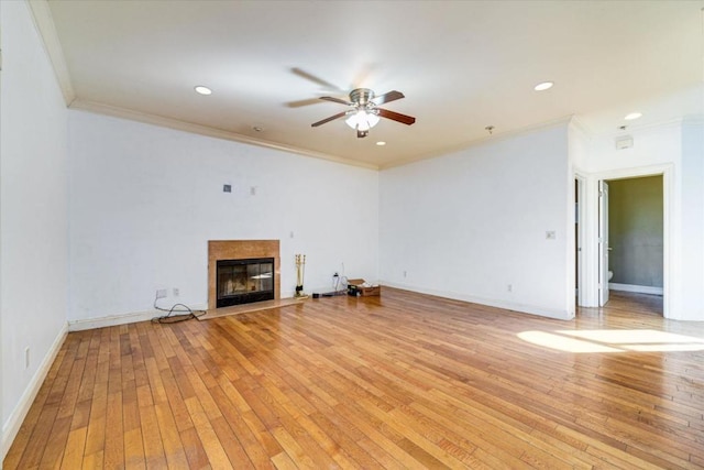 unfurnished living room with ceiling fan, light wood-type flooring, and ornamental molding