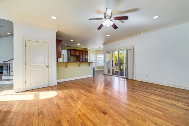 unfurnished living room featuring light wood-type flooring, ceiling fan, and ornamental molding