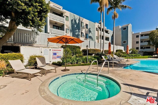 view of swimming pool with a community hot tub