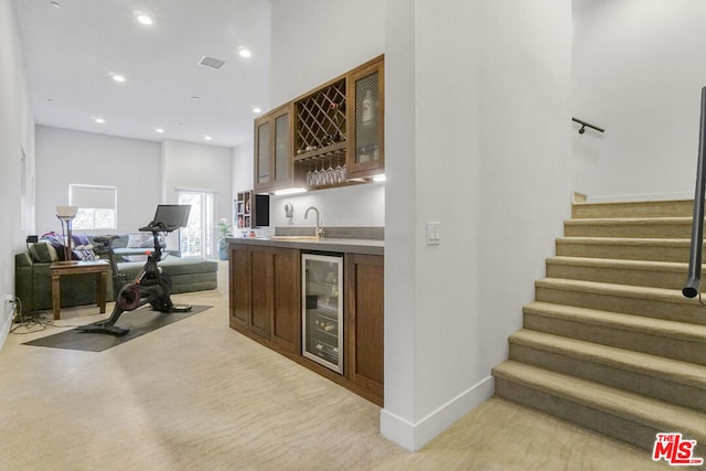 bar with wine cooler and sink