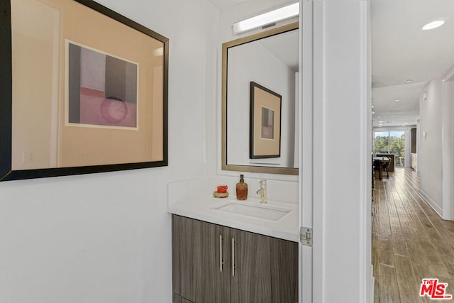 bathroom with hardwood / wood-style floors and vanity