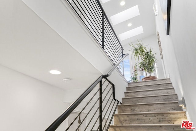 stairs with a skylight