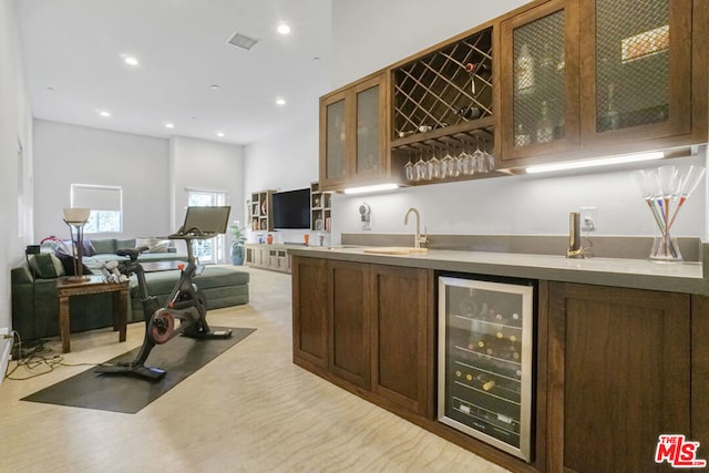 bar featuring sink and wine cooler