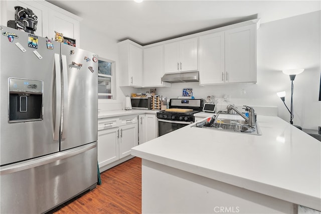 kitchen featuring white cabinets, sink, stainless steel appliances, and light hardwood / wood-style flooring