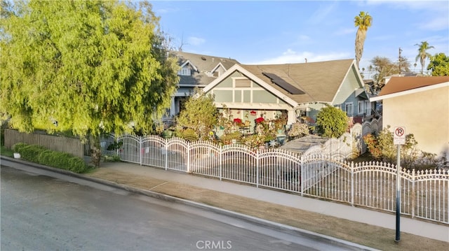 view of front of property featuring solar panels