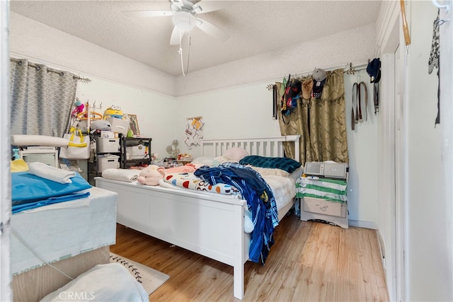 bedroom with ceiling fan and hardwood / wood-style flooring