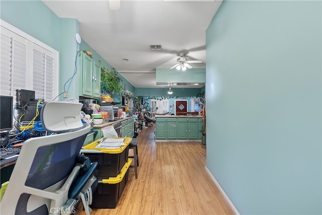 kitchen featuring green cabinets, light hardwood / wood-style floors, and ceiling fan