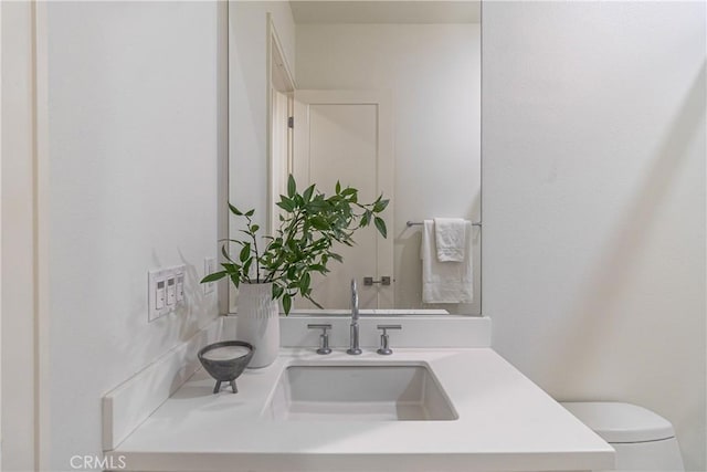 bathroom with toilet and vanity