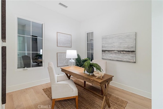 office space with light hardwood / wood-style flooring