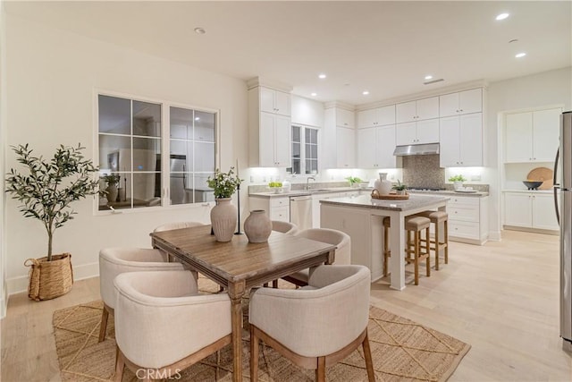 dining room featuring light wood-type flooring and sink