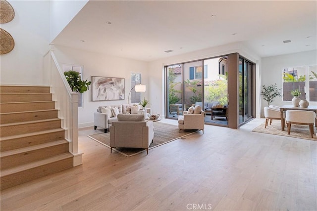 living room featuring a healthy amount of sunlight and light hardwood / wood-style floors