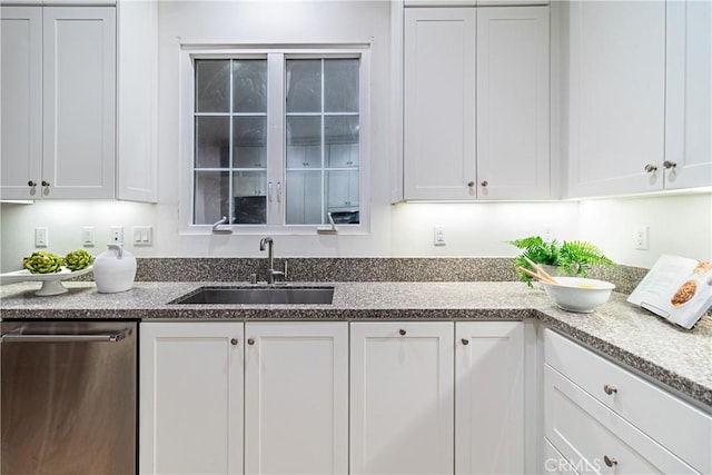 kitchen featuring white cabinetry, stainless steel dishwasher, and sink