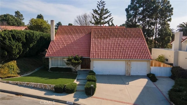 view of front of house featuring a garage and a front lawn