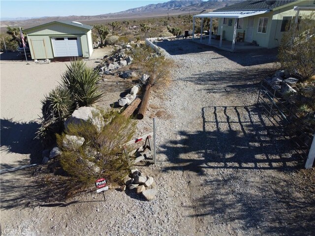 view of yard with a storage shed and a mountain view