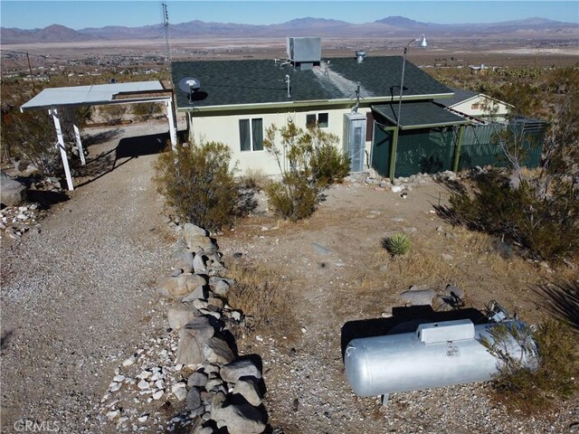 rear view of house featuring a mountain view