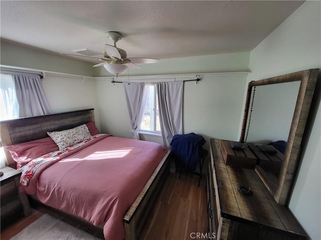 bedroom with wood-type flooring and ceiling fan