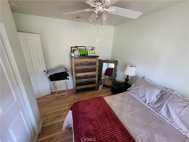 bedroom with ceiling fan and hardwood / wood-style floors