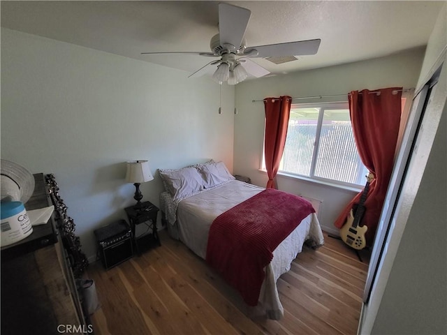 bedroom featuring ceiling fan and dark hardwood / wood-style flooring