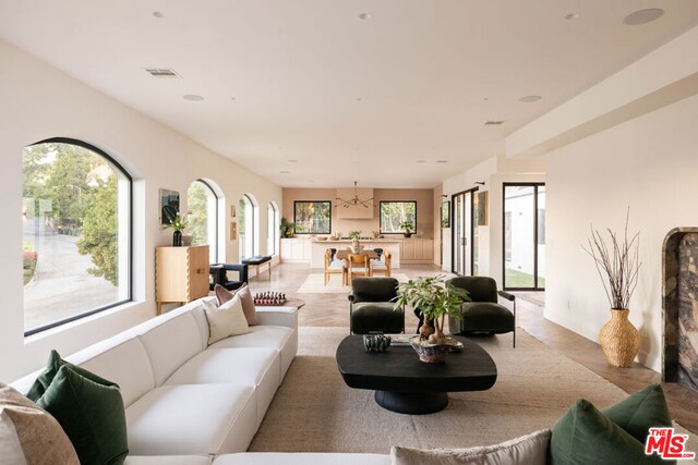 living room featuring a notable chandelier