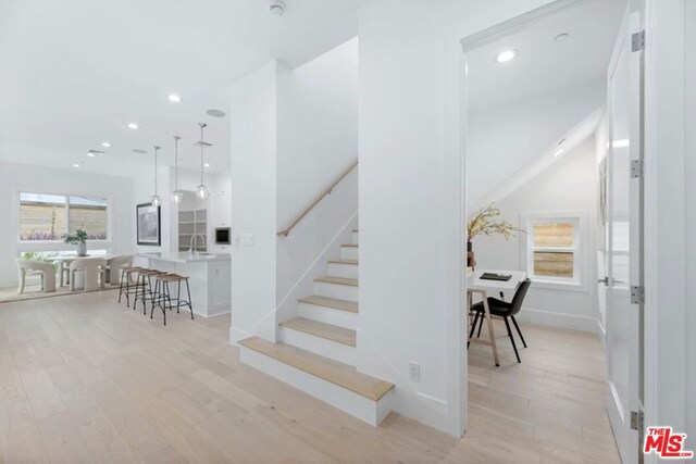 stairs with sink and hardwood / wood-style flooring