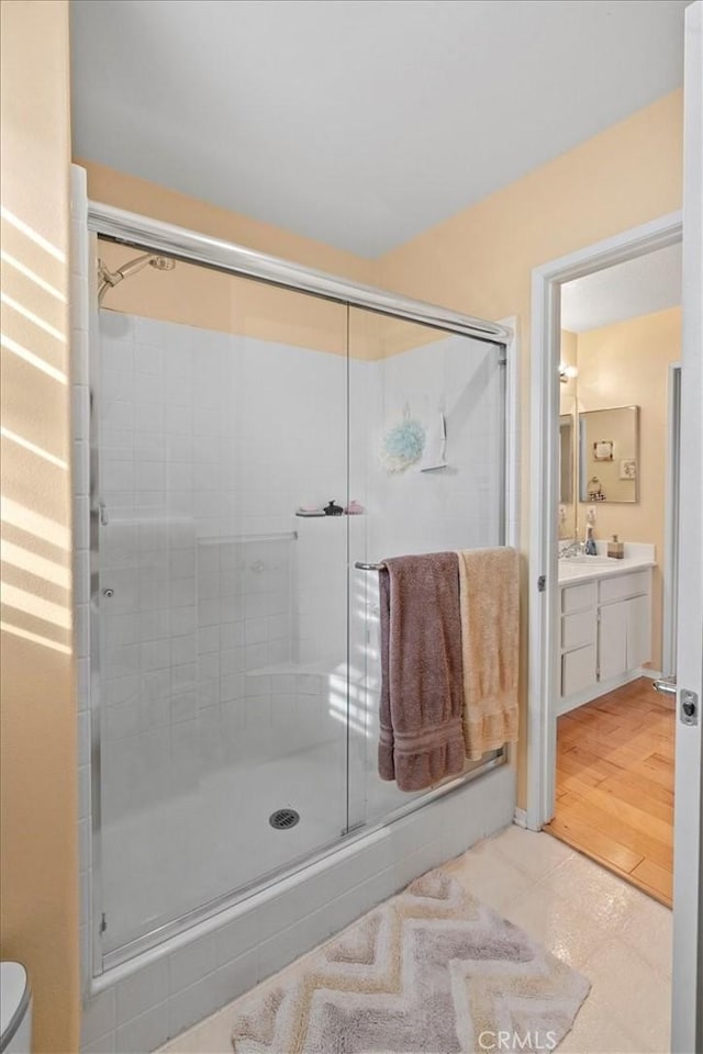 full bath with vanity and a shower stall