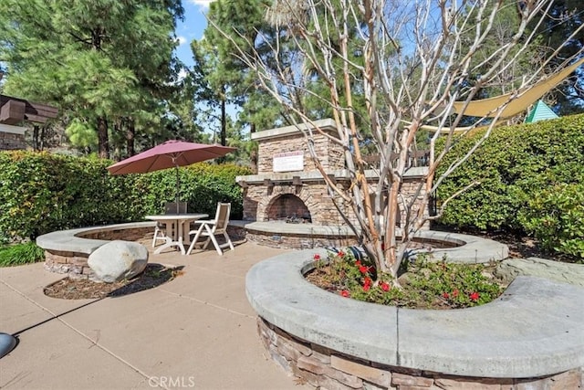 view of patio / terrace with an outdoor stone fireplace