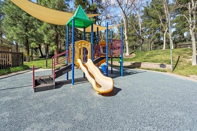 community jungle gym with a lawn