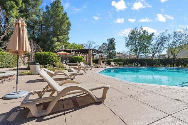 view of swimming pool featuring a patio, a fenced in pool, and a pergola