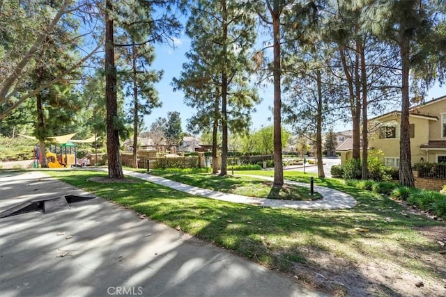 view of community with playground community and a lawn