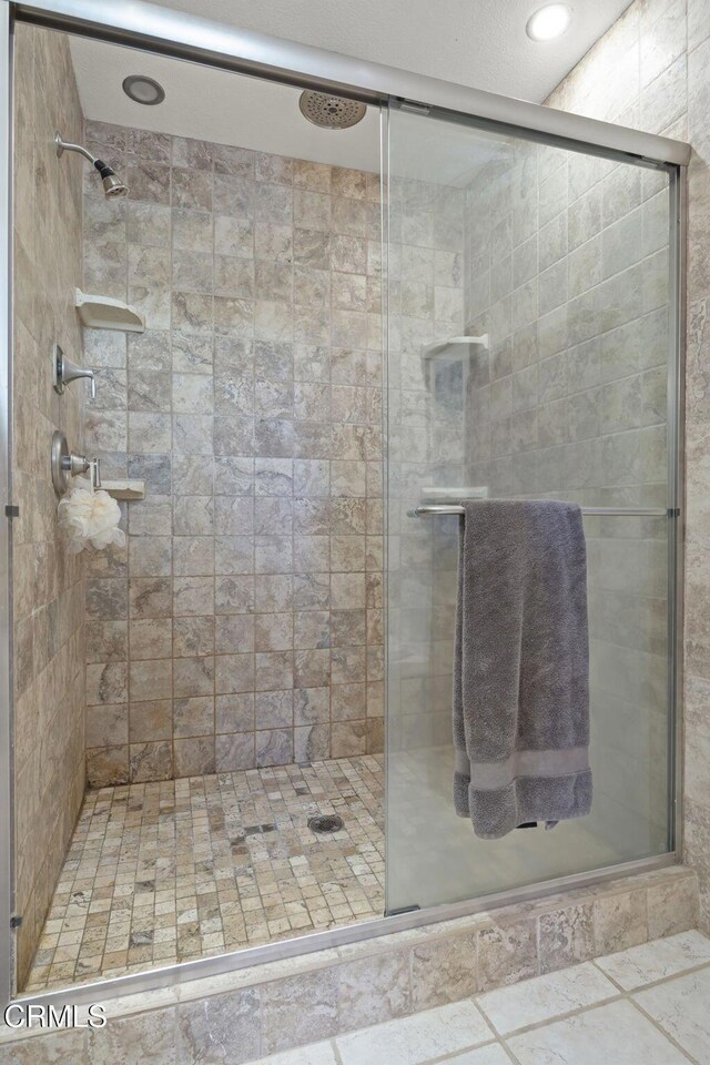 bathroom with a shower with shower door