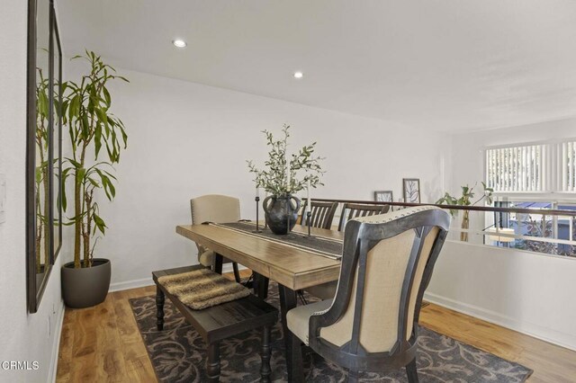 dining space with hardwood / wood-style flooring