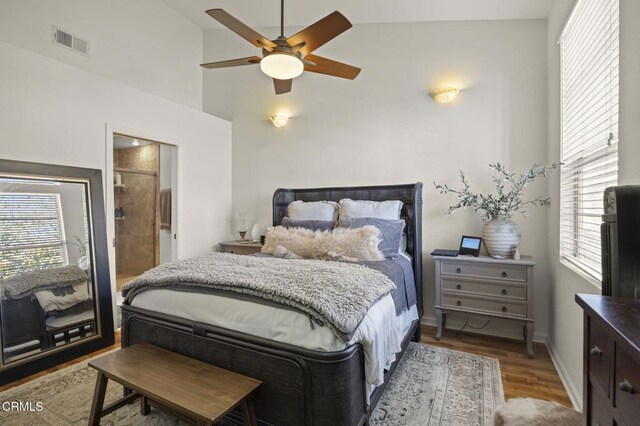 bedroom with ceiling fan, vaulted ceiling, and hardwood / wood-style floors