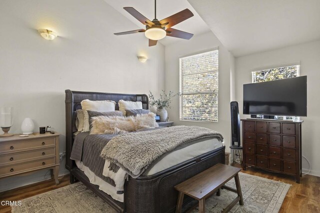 bedroom featuring ceiling fan, vaulted ceiling, and dark hardwood / wood-style floors