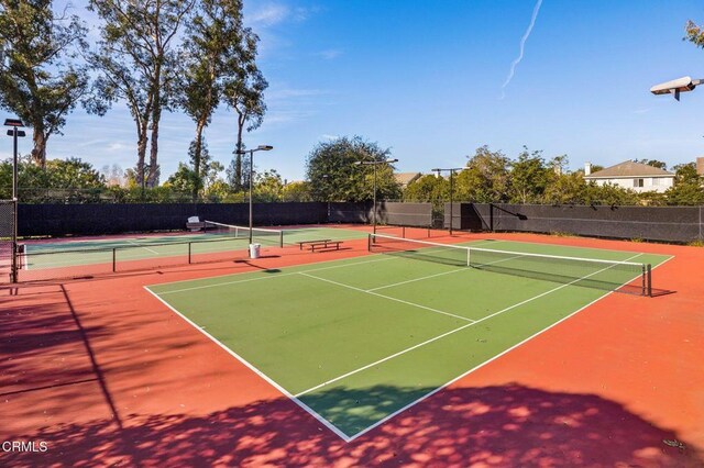 view of tennis court featuring basketball hoop