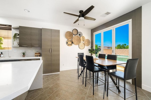 tiled dining room with ceiling fan