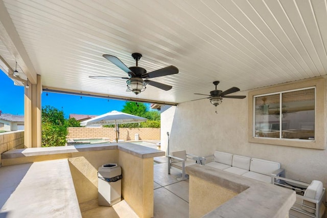 view of patio / terrace with ceiling fan and exterior bar