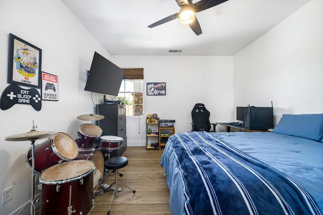 bedroom with ceiling fan and hardwood / wood-style floors