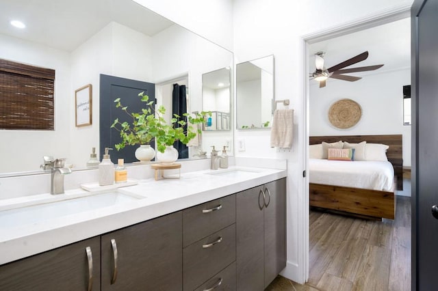 bathroom with ceiling fan, wood-type flooring, and vanity