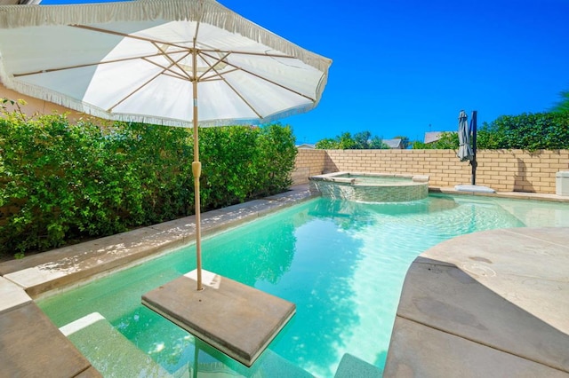 view of swimming pool with an in ground hot tub