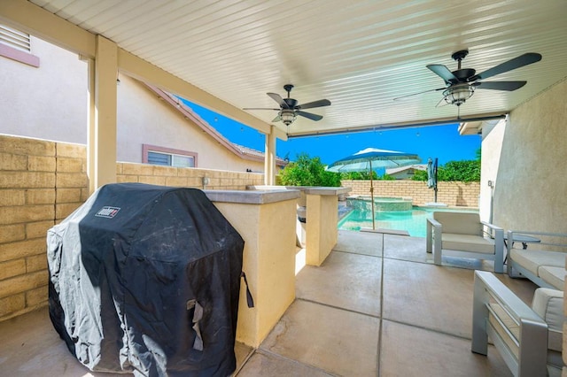 view of patio / terrace with a bar, a grill, and a fenced in pool