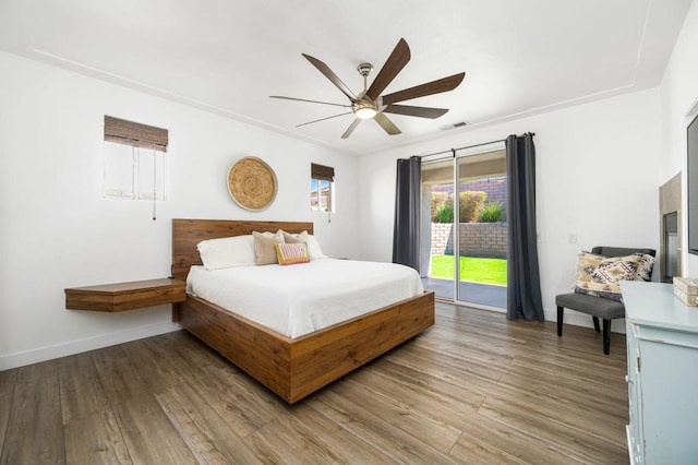 bedroom with ceiling fan, access to outside, and hardwood / wood-style floors