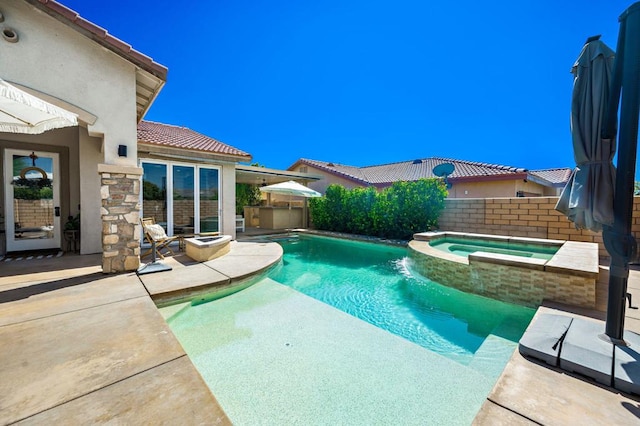 view of pool featuring a patio area and an in ground hot tub