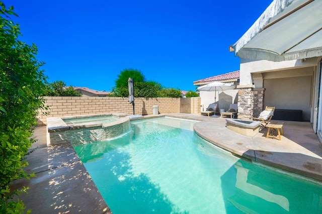 view of pool with a patio area and an in ground hot tub